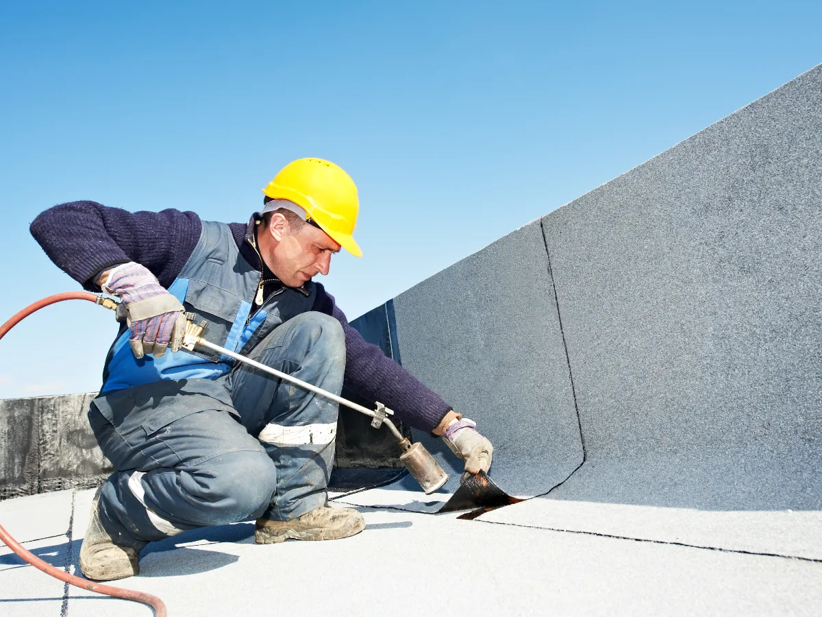A roofer laying a new flat roof